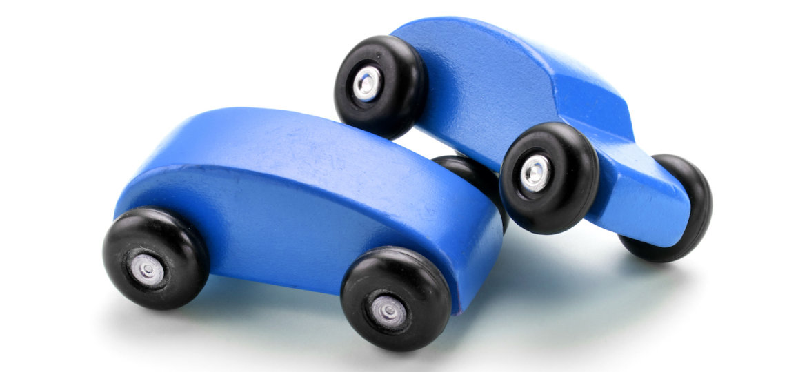 Blue toy car crash against white background