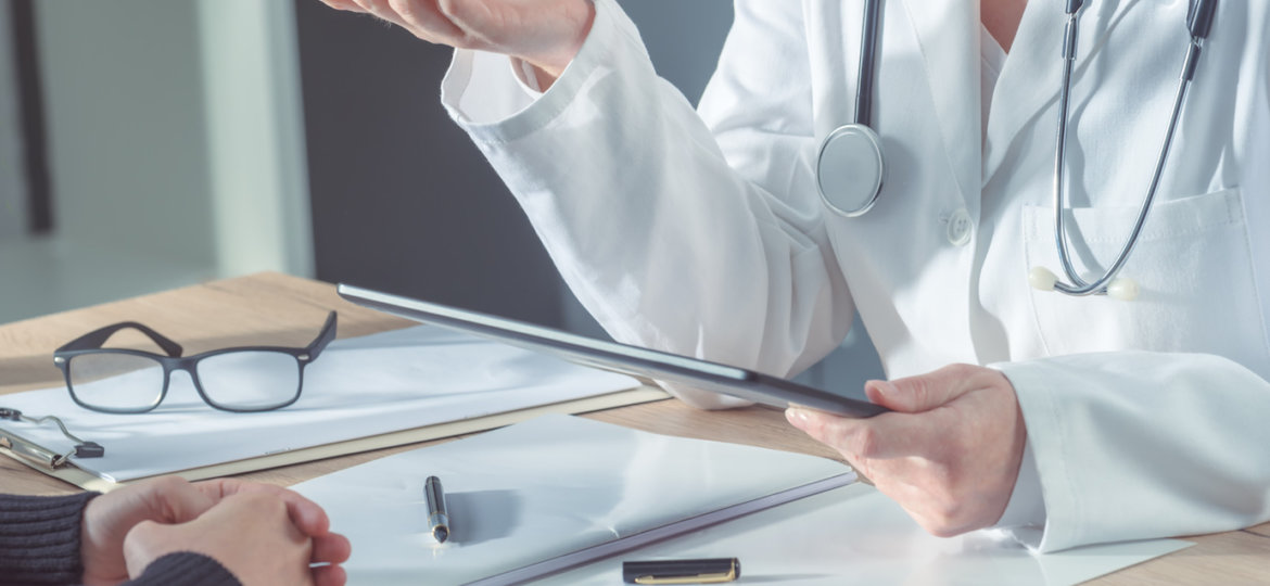 Doctor advising patient in hospital office